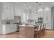 Bright kitchen with white cabinetry, stainless steel appliances, and barstool seating at 324 Waldo St, Cary, NC 27511