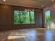 Spacious living room with hardwood floors, modern lighting, and large windows overlooking a lush landscape at 324 Waldo St, Cary, NC 27511