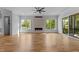 Spacious living room with fireplace, hardwood floors, ceiling fan, and view of the outdoors at 324 Waldo St, Cary, NC 27511