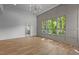 Bright living room boasts hardwood floors, modern lighting and large windows showcasing a view at 324 Waldo St, Cary, NC 27511