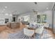 Open concept living space with dining room, kitchen, and living room with hardwood floors and natural light at 324 Waldo St, Cary, NC 27511