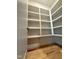 Spacious pantry featuring bright white custom shelving and convenient storage options at 324 Waldo St, Cary, NC 27511