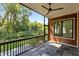 Covered porch with stone flooring, wood paneling, and views of the backyard at 324 Waldo St, Cary, NC 27511