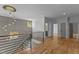 Upstairs hallway features hardwood floors, decorative lighting and an elegant staircase with black metal rails at 324 Waldo St, Cary, NC 27511
