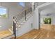 Modern staircase with hardwood treads, black metal railings, and large windows allowing for natural light at 324 Waldo St, Cary, NC 27511