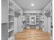 Spacious walk-in closet with custom shelving and mirrored vanity perfect for storage at 324 Waldo St, Cary, NC 27511