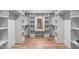 Walk-in closet with custom shelving and storage, with a mirror to another part of the closet at 324 Waldo St, Cary, NC 27511
