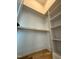 Bright walk-in closet with wooden rods and white shelving provides ample and organized storage space at 324 Waldo St, Cary, NC 27511