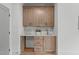 Elegant wet bar featuring custom wood cabinets, quartz countertop, and beverage storage at 324 Waldo St, Cary, NC 27511