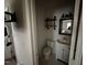 Small bathroom with toilet, sink, and mirror at 3395 Nc Hwy 210, Smithfield, NC 27577