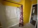 Bathroom with shower/tub combo and yellow walls at 3395 Nc Hwy 210, Smithfield, NC 27577