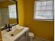 Bathroom with gray vanity and yellow walls at 3395 Nc Hwy 210, Smithfield, NC 27577