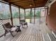 Relaxing screened porch with wooden chairs at 3395 Nc Hwy 210, Smithfield, NC 27577