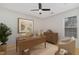 Bright bedroom featuring light hardwood floors, a ceiling fan, and decorated with virtual staging at 3413 Thistledown Ct, Efland, NC 27243