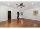 Spacious bedroom with hardwood floors, ceiling fan, and two entrances to bathroom at 3413 Thistledown Ct, Efland, NC 27243