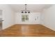 Bright dining room with hardwood floors and modern lighting at 3413 Thistledown Ct, Efland, NC 27243