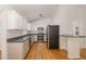 Functional kitchen with white cabinets, stainless steel appliances, and breakfast bar seating at 3413 Thistledown Ct, Efland, NC 27243