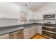 Well-lit kitchen features a stainless steel dishwasher, oven, and ample counter space at 3413 Thistledown Ct, Efland, NC 27243
