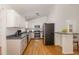 Bright kitchen with white cabinets, stainless steel appliances, and convenient breakfast bar at 3413 Thistledown Ct, Efland, NC 27243