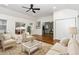 Cozy living room with comfortable seating, hardwood floors, and access to the kitchen at 3413 Thistledown Ct, Efland, NC 27243