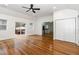Spacious living room with hardwood floors, ceiling fan, and sliding glass doors to a deck at 3413 Thistledown Ct, Efland, NC 27243