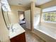 Bathroom boasts double sinks, a large soaking tub, and lots of light from a bright window at 4809 Kaycee Ct, Raleigh, NC 27616
