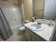 Full bathroom with shower-tub combination and vanity with sink, flowers, and toiletries at 4809 Kaycee Ct, Raleigh, NC 27616