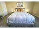 Bedroom featuring soft carpet, neutral walls, natural light, and a relaxing queen bed at 4809 Kaycee Ct, Raleigh, NC 27616