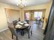 Elegant dining room with grey seating for four, offering a view into the living area and front entrance at 4809 Kaycee Ct, Raleigh, NC 27616