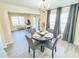Charming dining area with a set table, blending seamlessly into a well-lit living space and home office at 4809 Kaycee Ct, Raleigh, NC 27616