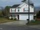 Charming two-story home with white siding, red shutters, and a spacious two-car garage at 4809 Kaycee Ct, Raleigh, NC 27616