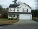 Two story home with white siding and red shutters; has a two car garage and landscaped front at 4809 Kaycee Ct, Raleigh, NC 27616