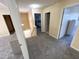 Upstairs hallway with neutral carpet, warm wall color, and doorways to bedrooms and storage at 4809 Kaycee Ct, Raleigh, NC 27616