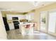 Modern kitchen with island, white cabinets, black appliances, and lots of natural light at 4809 Kaycee Ct, Raleigh, NC 27616