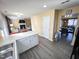 Open concept kitchen with island, open to dining and living areas, with vinyl plank flooring at 4809 Kaycee Ct, Raleigh, NC 27616