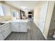 Open concept kitchen with island that leads to the living room with fireplace and television at 4809 Kaycee Ct, Raleigh, NC 27616