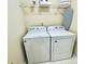Washer and dryer with storage shelf and ironing board in the laundry room at 4809 Kaycee Ct, Raleigh, NC 27616