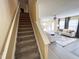 Open-concept living space is revealed from the top of the stairs, featuring modern decor and abundant light at 4809 Kaycee Ct, Raleigh, NC 27616