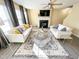 Cozy living room with two sofas, fireplace, ceiling fan, gray curtains and light gray wood floors at 4809 Kaycee Ct, Raleigh, NC 27616