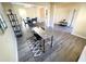 Inviting open-concept living room with grey flooring seamlessly flows into the dining area and features a stylish desk area at 4809 Kaycee Ct, Raleigh, NC 27616