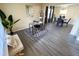 Bright and airy living room showcasing grey flooring, with an adjacent dining area and decorative plant for added charm at 4809 Kaycee Ct, Raleigh, NC 27616
