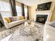 Sun-filled living room includes a fireplace, gray curtains, and light gray wood floors at 4809 Kaycee Ct, Raleigh, NC 27616