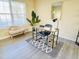 Cozy living room corner with grey floors, a stylish desk setup, and natural light from a window at 4809 Kaycee Ct, Raleigh, NC 27616