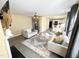 An open-concept living room leads into the kitchen with lots of light and gray wood-look flooring at 4809 Kaycee Ct, Raleigh, NC 27616