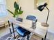 Home office space boasting desk with lamp and chair, adorned with chic decor accents at 4809 Kaycee Ct, Raleigh, NC 27616