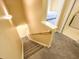Carpeted staircase leads to a cozy upstairs hallway with a bedroom and laundry area entrance at 4809 Kaycee Ct, Raleigh, NC 27616