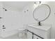 Bathroom featuring a shower-tub combo, stylish vanity with black hardware, and a round mirror at 5709 Russell Rd, Durham, NC 27712