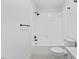 A bathroom features a white tiled shower-tub combo and black fixtures at 5709 Russell Rd, Durham, NC 27712