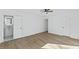 A bright bedroom with wood floors, white walls, and a ceiling fan with light at 5709 Russell Rd, Durham, NC 27712