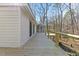 Long wooden deck with cable railing connects to a screened-in porch at 5709 Russell Rd, Durham, NC 27712